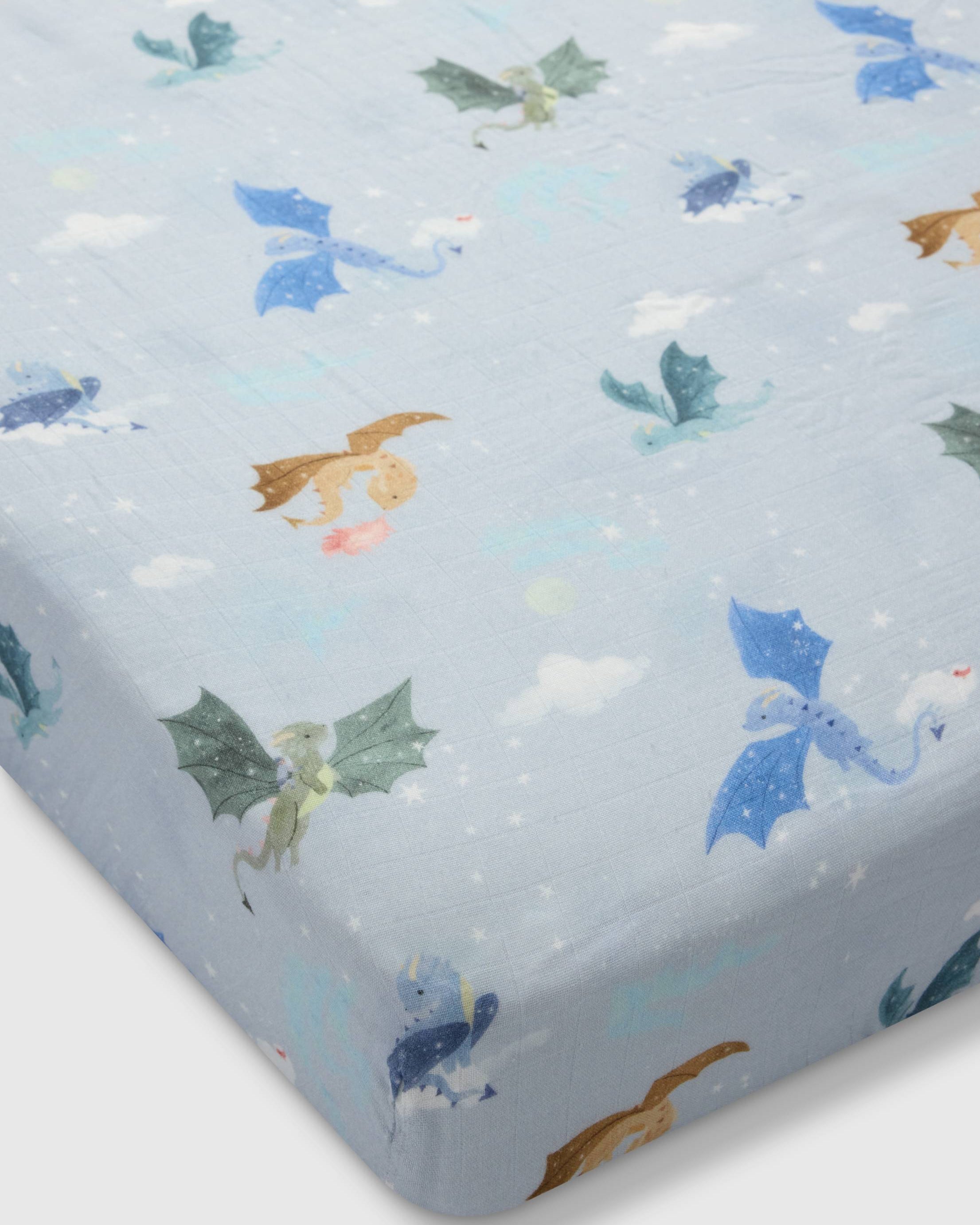 Loulou Lollipop muslin fitted crib sheet in Magical Dragons for US standard crib — front view on white background