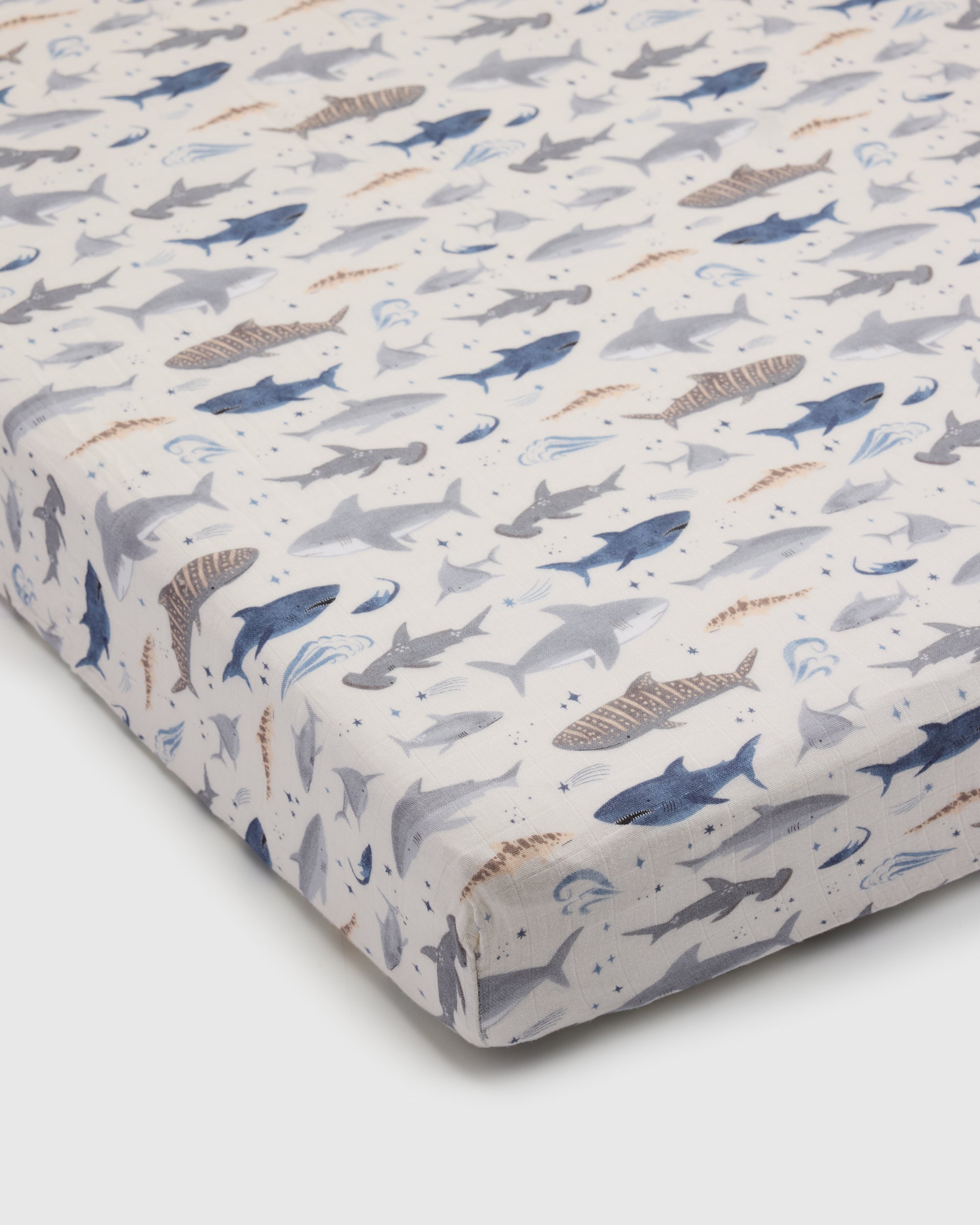 Loulou Lollipop muslin fitted crib sheet in Smiley Sharks for US standard crib — front view on white background
