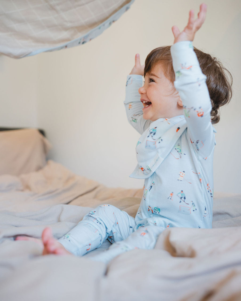 Loulou Lollipop TENCEL baby sleeper footie pajamas in Ice Hockey — front view on white background