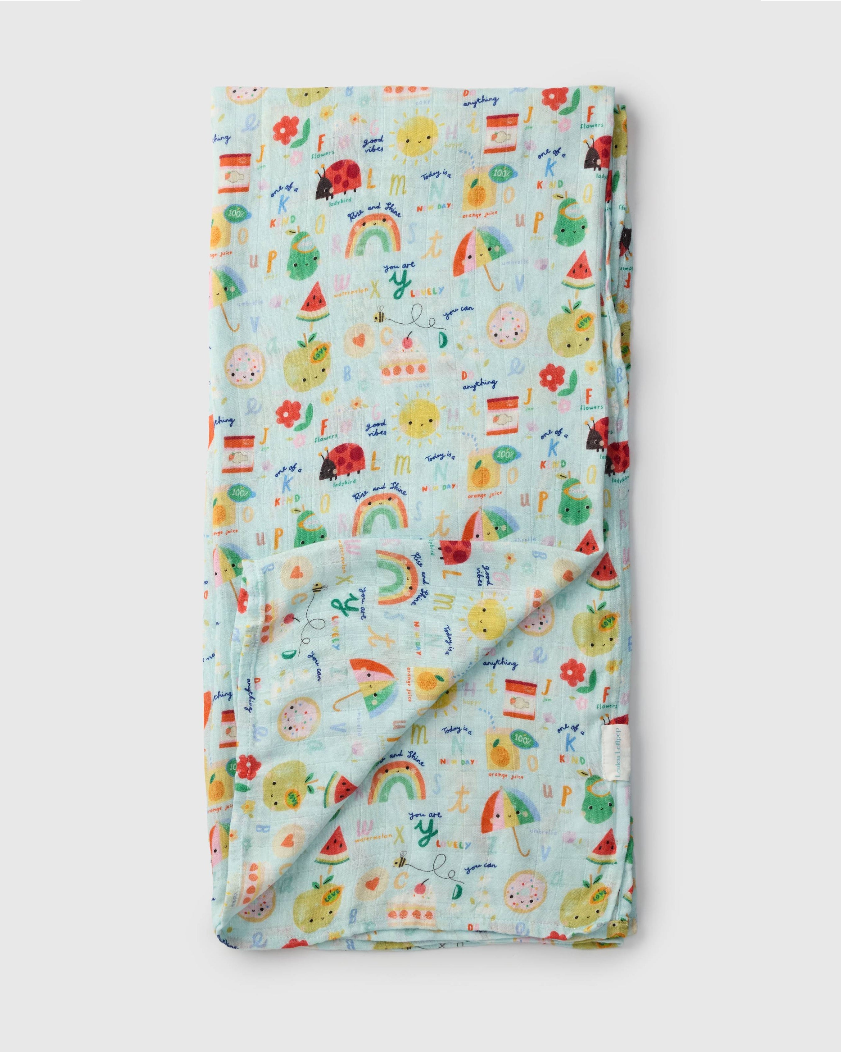 Loulou Lollipop bamboo cotton muslin swaddle blanket in Alphabet Smiles — front view on white background