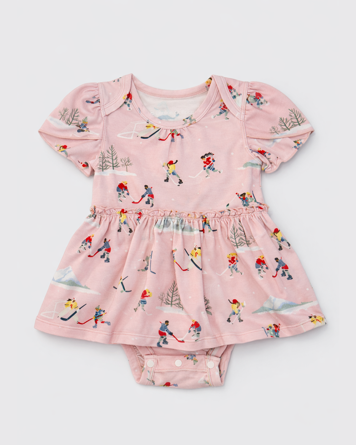 Pink baby dress with winter hockey sport on a light gray background