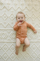 Loulou Lollipop Long Sleeve Bodysuit in Rust Geo — front view on white background