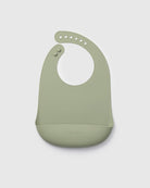 Green silicone bib on a light gray background